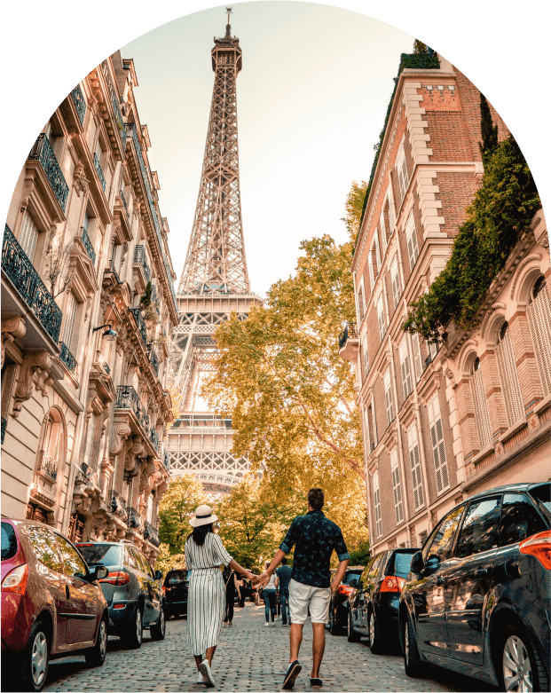 Couple walking towards Eiffel Tower, Paris street.